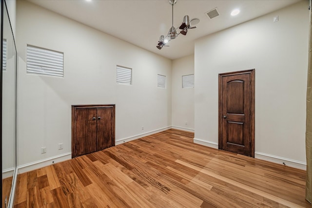 spare room with visible vents, recessed lighting, baseboards, and wood finished floors