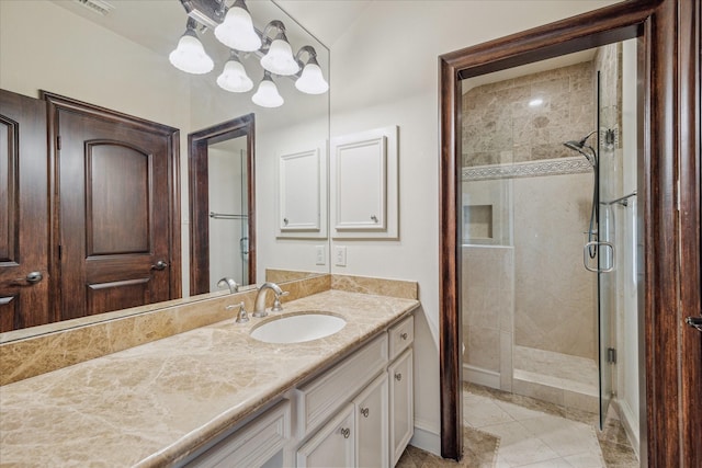 full bath featuring vanity, a shower stall, and baseboards