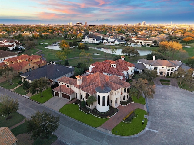 bird's eye view featuring a residential view and a water view