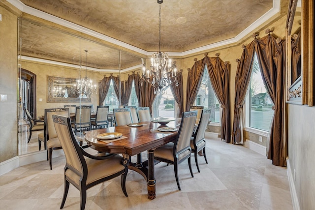 dining space with a raised ceiling, an inviting chandelier, and crown molding