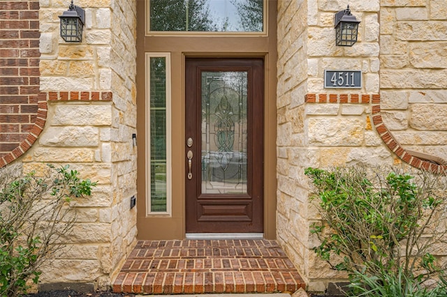 property entrance featuring stone siding