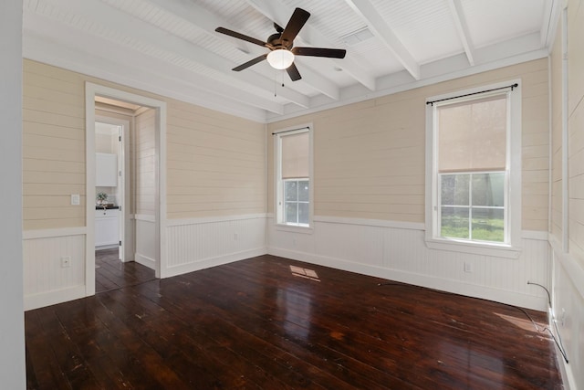 unfurnished room featuring beamed ceiling, wood-type flooring, and a ceiling fan