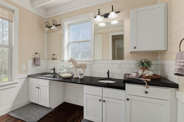 interior space featuring dark countertops, white cabinets, and a sink