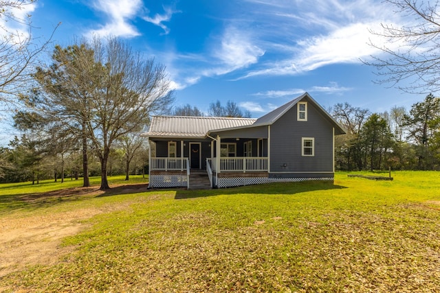 back of house with a yard, covered porch, and metal roof