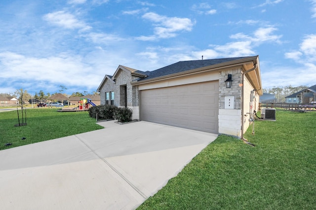 view of side of home featuring a lawn, driveway, stone siding, central AC, and a playground