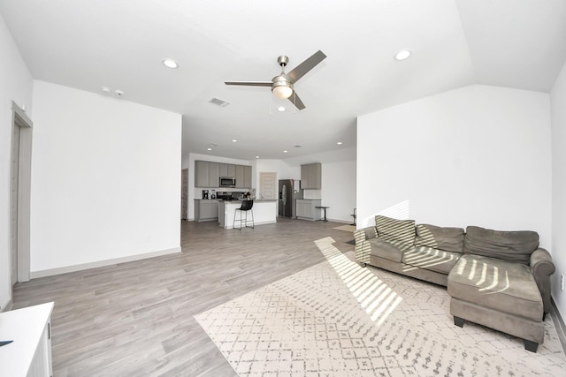 living area with recessed lighting, visible vents, light wood-style flooring, and a ceiling fan