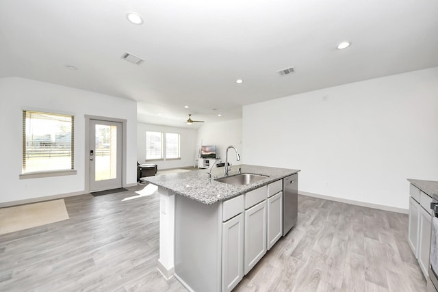 kitchen with dishwasher, open floor plan, visible vents, and a sink