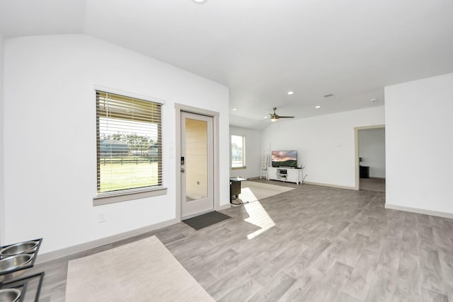 living room featuring light wood finished floors, recessed lighting, baseboards, and vaulted ceiling