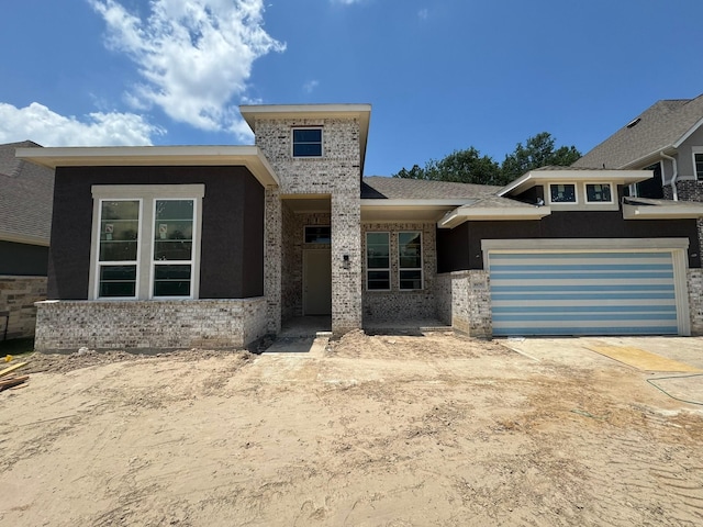 16178 Rustling Woods Rd, Conroe, TX 77302 - view of front facade featuring brick siding and driveway