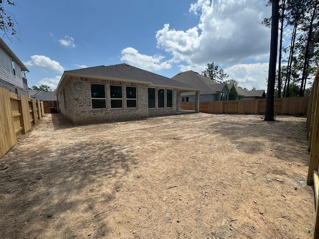 16178 Rustling Woods Rd, Conroe, TX 77302 - rear view of property with brick siding and a fenced backyard