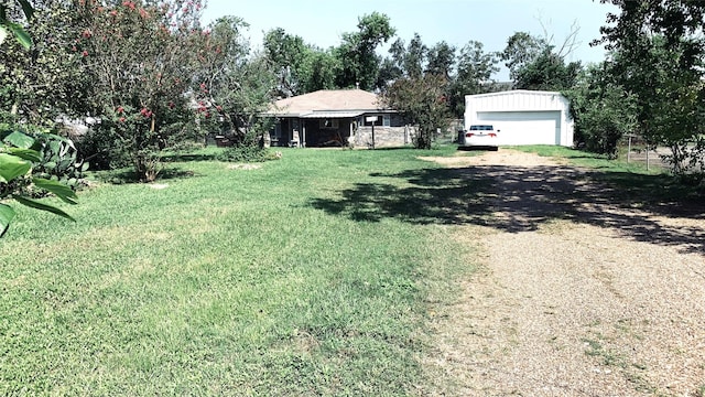 view of yard with an outbuilding and driveway