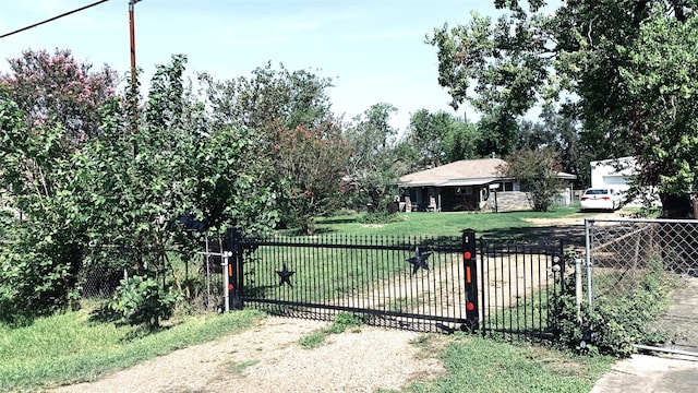 view of gate featuring a yard and fence