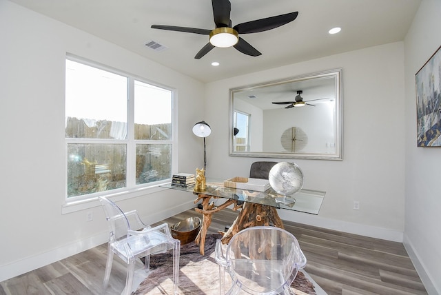 office featuring visible vents, wood finished floors, baseboards, and ceiling fan