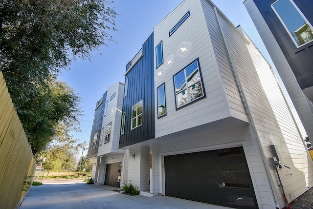 view of side of home featuring an attached garage and board and batten siding