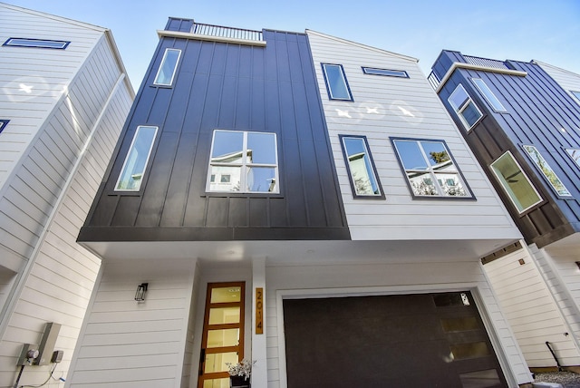 view of side of property with board and batten siding and a garage