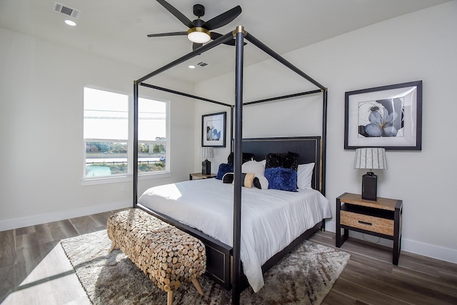 bedroom with recessed lighting, visible vents, baseboards, and wood finished floors