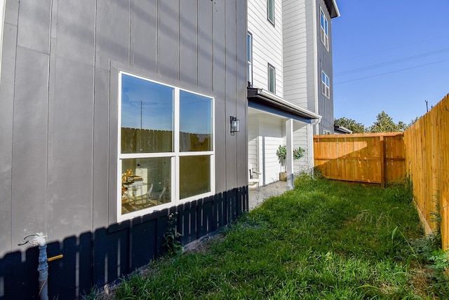 view of side of property featuring a yard and fence