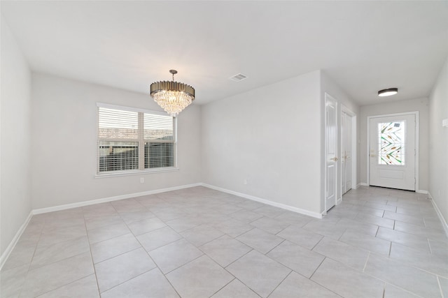 interior space featuring a wealth of natural light, visible vents, baseboards, and a notable chandelier