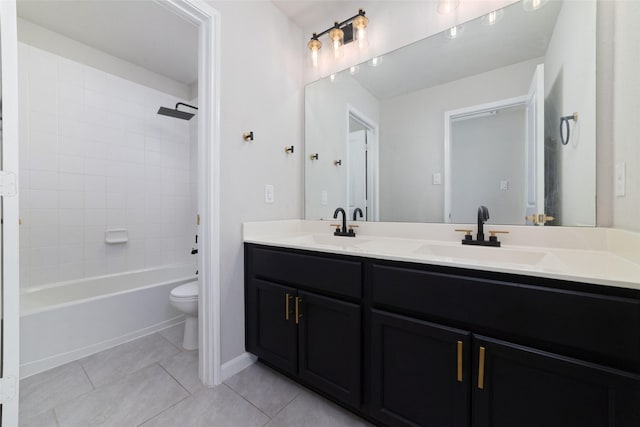 full bathroom with a sink, toilet, double vanity, and tile patterned floors