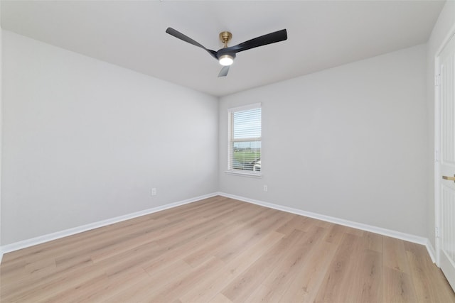 empty room with a ceiling fan, baseboards, and light wood finished floors