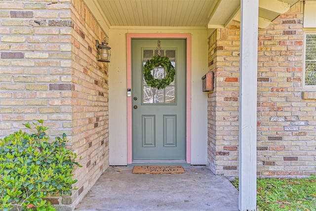 property entrance featuring brick siding