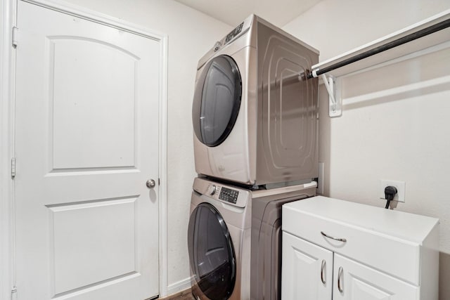 laundry area with cabinet space and stacked washer / drying machine