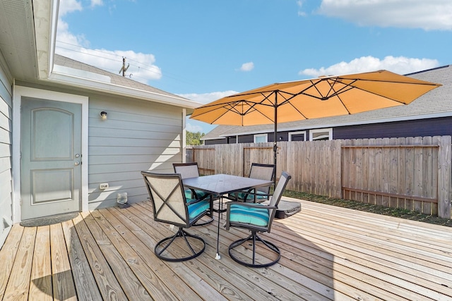 wooden deck featuring outdoor dining space and fence