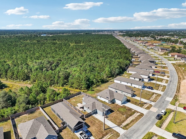 birds eye view of property featuring a forest view and a residential view