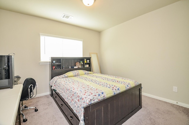 bedroom with light carpet, visible vents, and baseboards