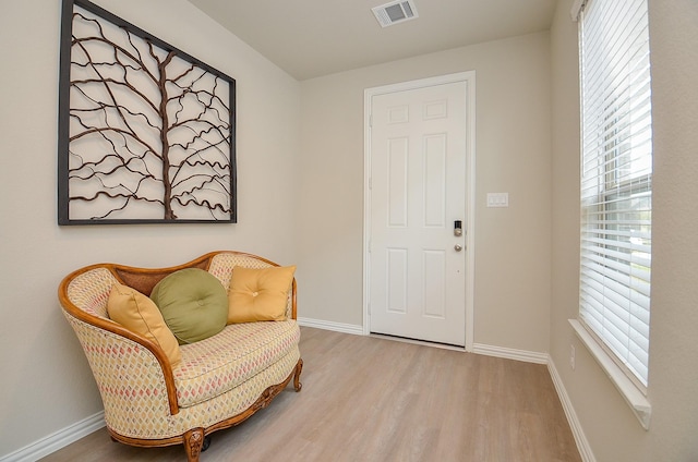 sitting room featuring plenty of natural light, wood finished floors, and visible vents