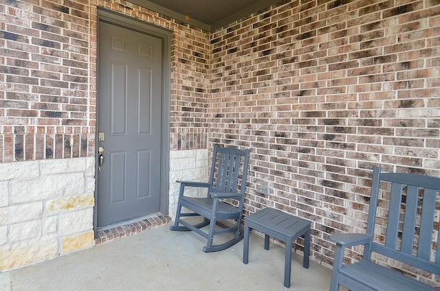 doorway to property featuring brick siding