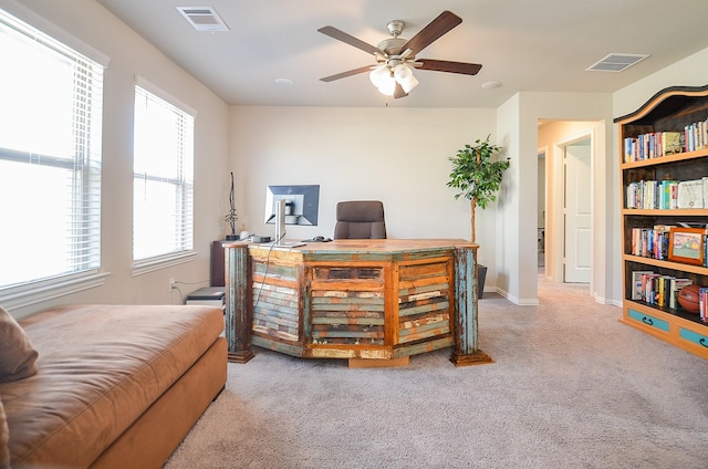 office featuring carpet flooring, baseboards, visible vents, and ceiling fan