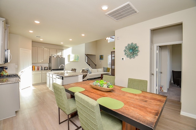 dining area featuring visible vents, recessed lighting, and light wood-style floors