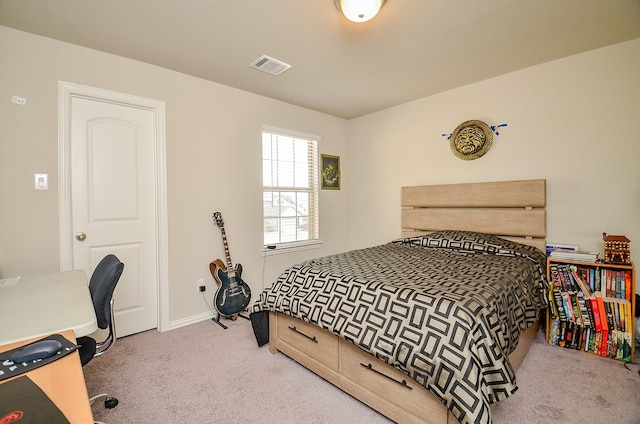 carpeted bedroom featuring visible vents