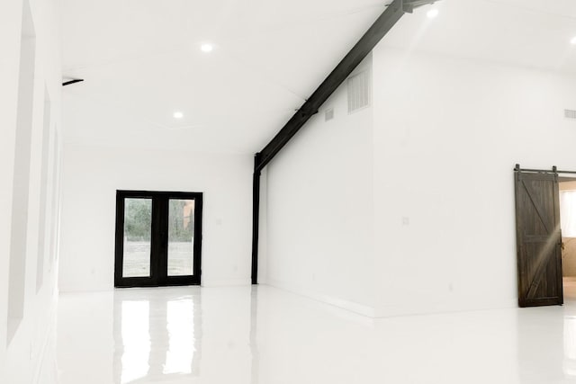 corridor featuring recessed lighting and a barn door