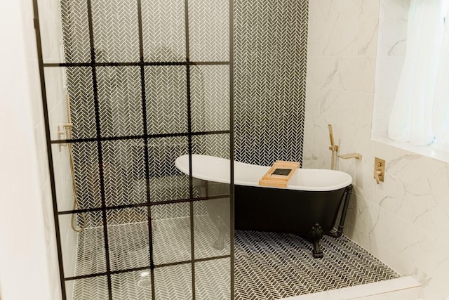 full bath featuring a soaking tub and tile walls