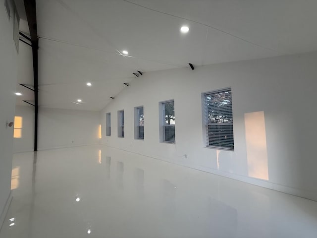 unfurnished room featuring recessed lighting and vaulted ceiling