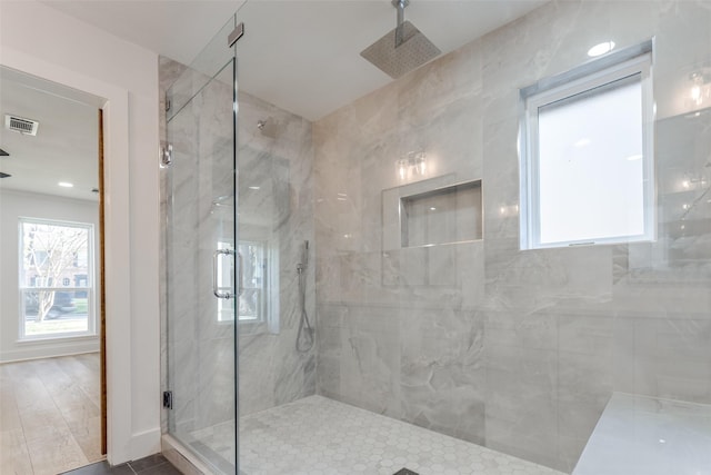 bathroom featuring a marble finish shower and visible vents