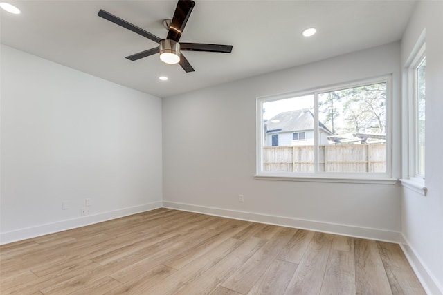 spare room with a ceiling fan, recessed lighting, baseboards, and light wood-type flooring