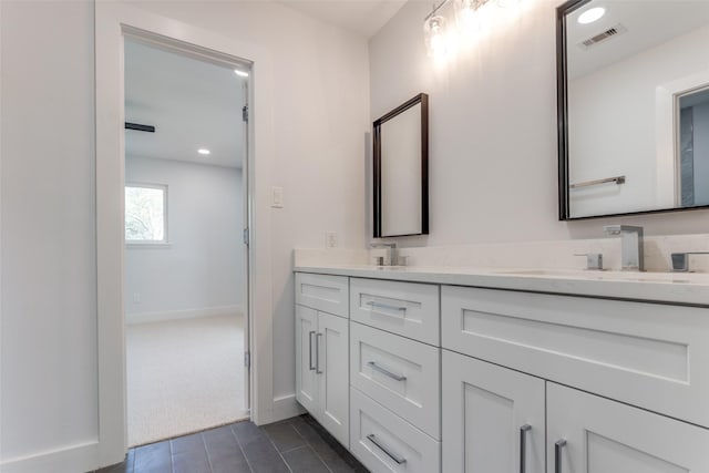 full bathroom with visible vents, baseboards, double vanity, recessed lighting, and a sink