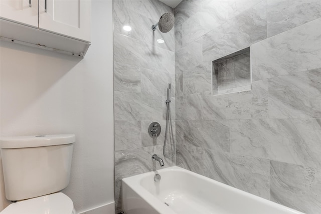 bathroom with toilet and bathing tub / shower combination