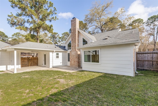 back of house featuring a patio area, a yard, and fence