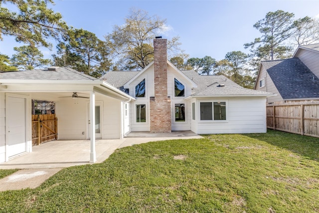 back of house with a patio area, a yard, fence, and roof with shingles