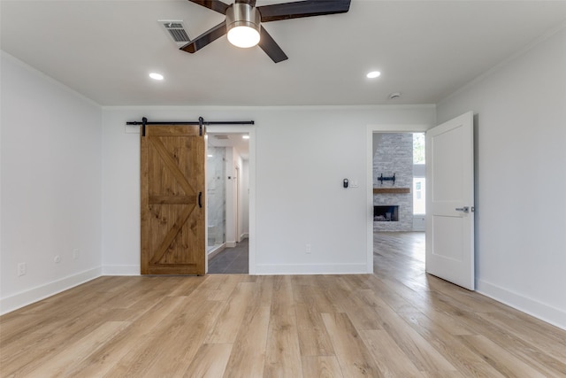 unfurnished bedroom featuring visible vents, light wood-style flooring, baseboards, and ornamental molding