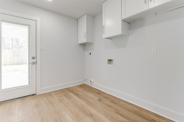 laundry room with electric dryer hookup, washer hookup, cabinet space, light wood-style floors, and baseboards