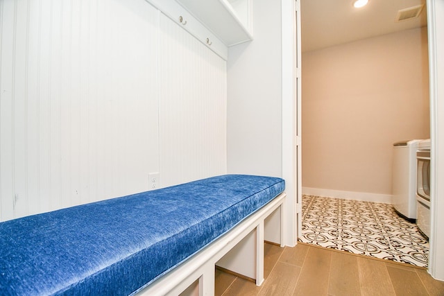 interior space featuring visible vents, baseboards, and wood finished floors