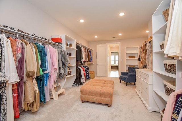 spacious closet featuring visible vents and light colored carpet