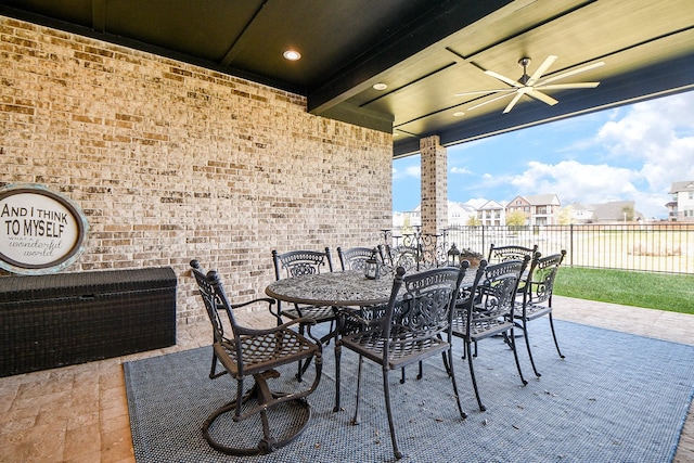 view of patio / terrace featuring outdoor dining space, fence, and a ceiling fan