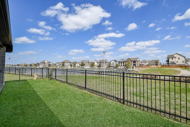 view of yard featuring a residential view and fence