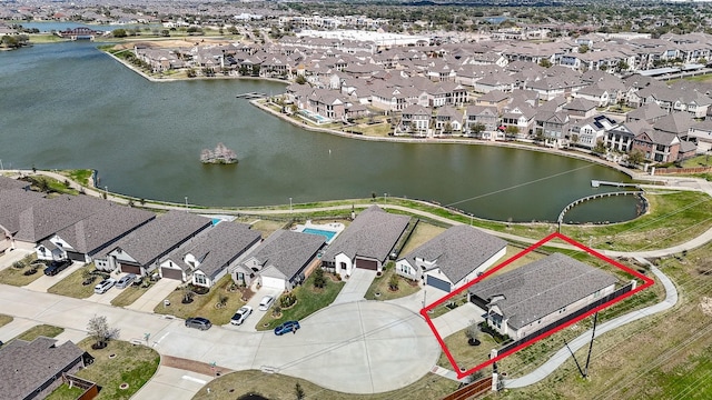 bird's eye view featuring a residential view and a water view